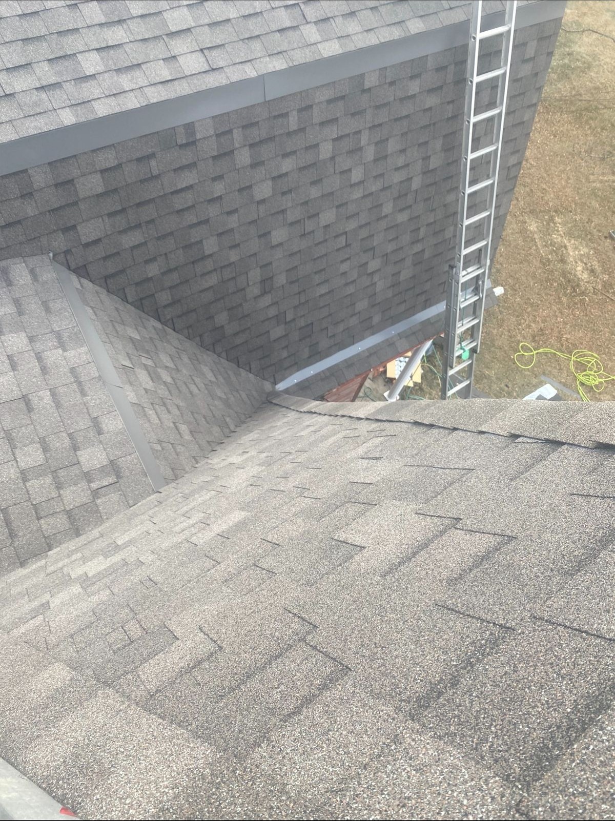 Complex roof valley and intersection showing precision shingle work