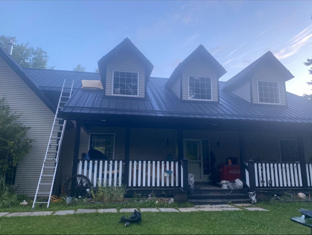 Metal roof detail showing standing seam panels on a Stony Plain residential home