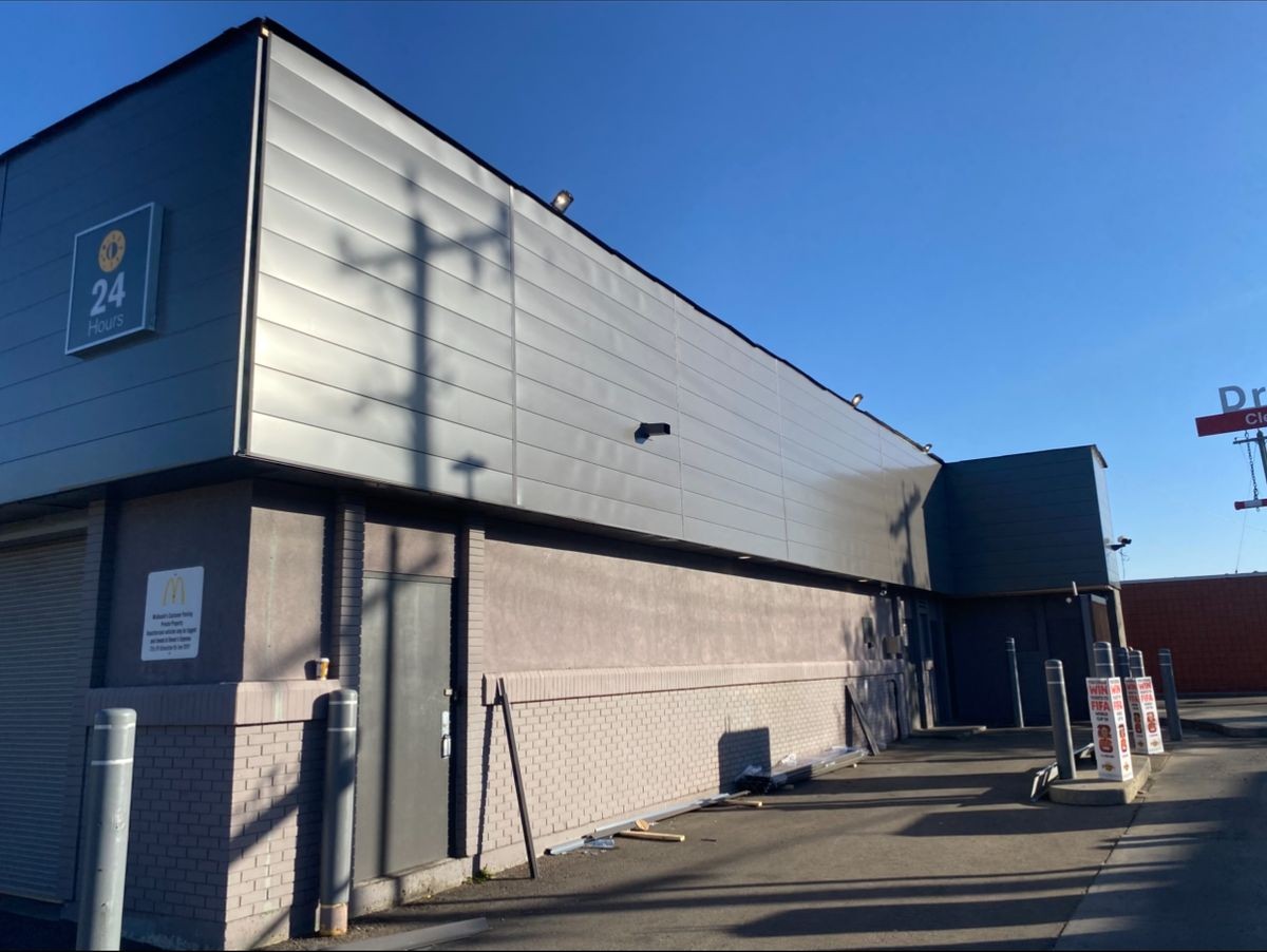 Kayan Contracting crew installing metal roofing panels on a Parkland County home