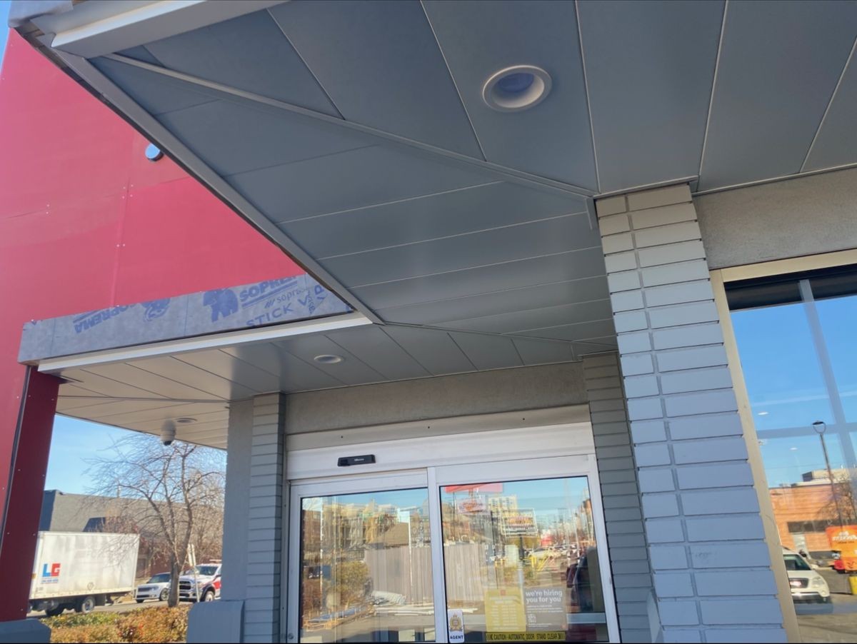 Storm damage roof repair showing new shingles installed after hail damage in Spruce Grove