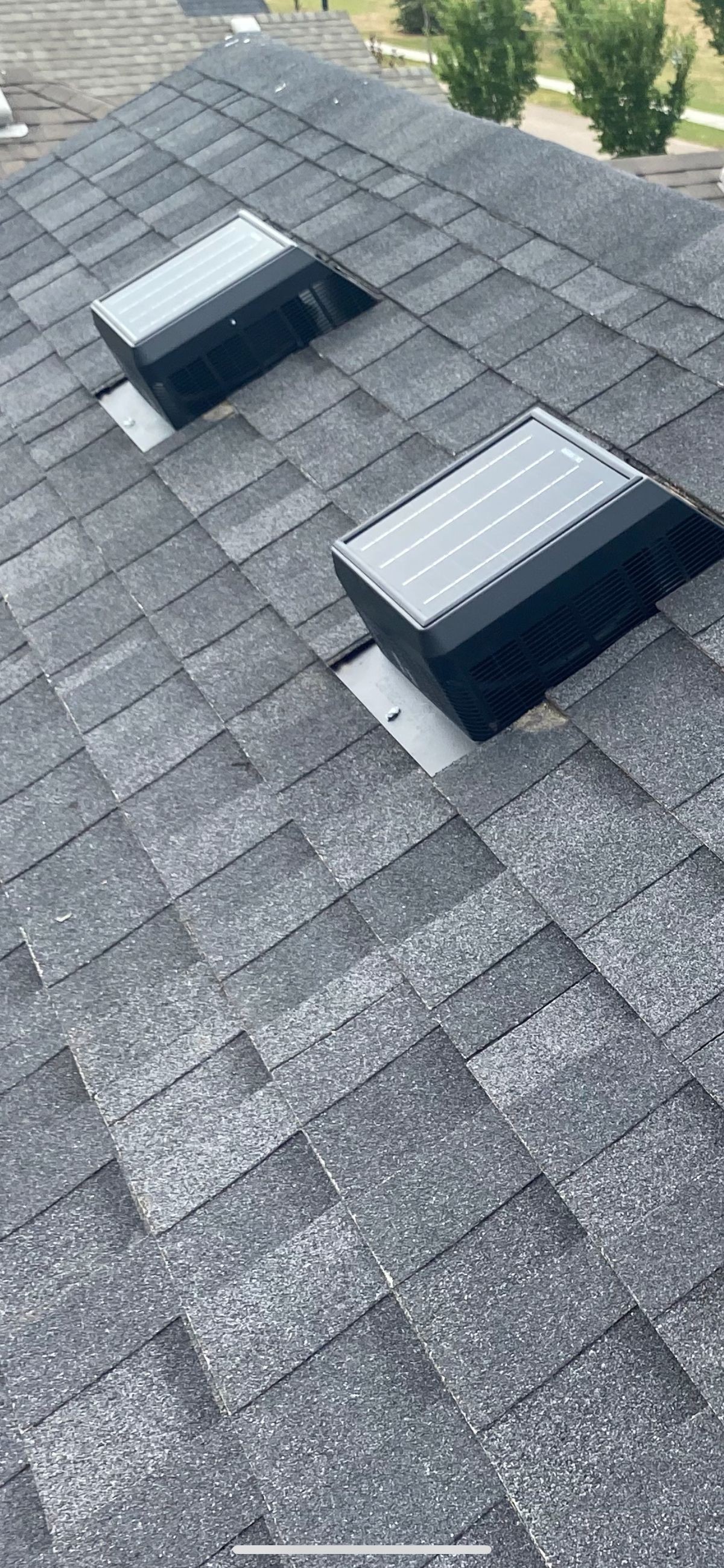 Solar-powered roof vents on freshly shingled roof